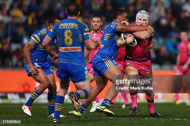 Nigel Plum of the Panthers is tackled during the round 18 NRL match between Parramatta Eels and the Penrith Panthers at Parramatta Stadium on July...