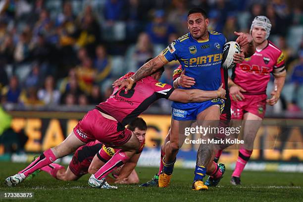 Reni Maitua of the Eels is tackled during the round 18 NRL match between Parramatta Eels and the Penrith Panthers at Parramatta Stadium on July 13,...