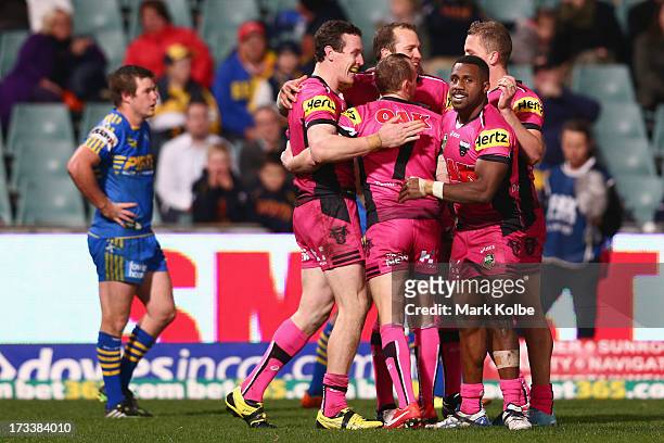 David Simmons of the Panthers celebrates with his team mates after scoring a try during the round 18 NRL match between Parramatta Eels and the...