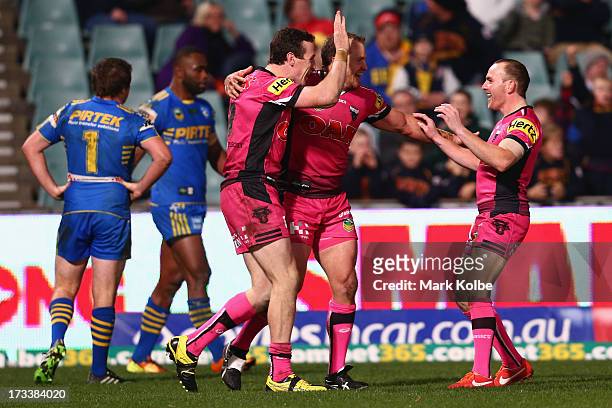 David Simmons of the Panthers celebrates with his team mate Luke Leiws of the Panthers after scoring a try during the round 18 NRL match between...