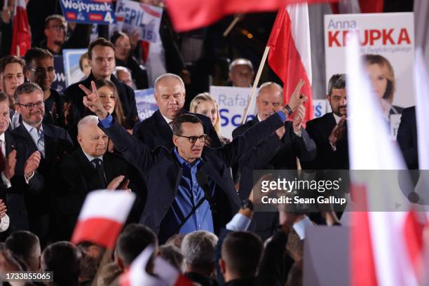 Polish Prime Minister and leading member of the ruling national conservative Law and Justice party Mateusz Morawiecki gives a victory gesture after...