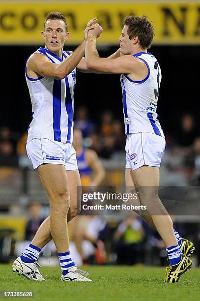 Drew Petrie of the Kangaroos celebrates a goal with Ryan Bastinac during the round 16 AFL match between the Brisbane Lions and the North Melbourne...