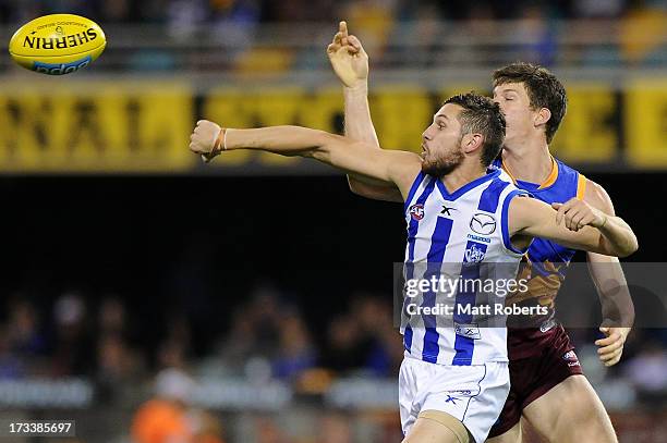 Aaron Black of the Kangaroos spoils the mark of Justin Clarke of the Lions during the round 16 AFL match between the Brisbane Lions and the North...