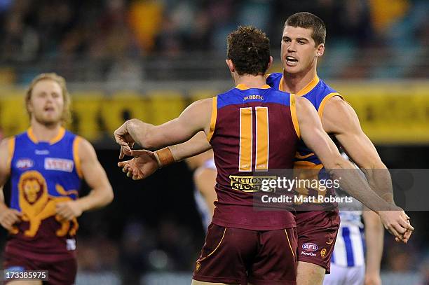 Pearce Hanley of the Lions celebrates a goal with Jonathan Brown during the round 16 AFL match between the Brisbane Lions and the North Melbourne...