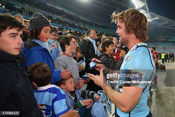 Pat McCutcheon of the Waratahs signs autographs following the round 20 Super Rugby match between the Waratahs and the Reds at ANZ Stadium on July 13,...