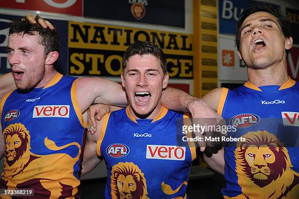 Pearce Hanley, Dayne Zorko and Jed Adcock of the Lions celebrate after the round 16 AFL match between the Brisbane Lions and the North Melbourne...