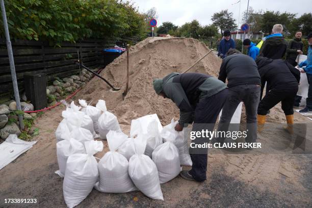 Sandbags are filled at Kelstrup Strand near Haderslev, southern Denmark on October 19 after a weather warning was issued for the area. According to...