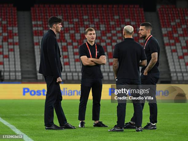 Cristiano Biraghi, Alessandro Bastoni and Nicolo Barella of Italy look on during pitch inspection at Stadio San Nicola on October 13, 2023 in Bari,...