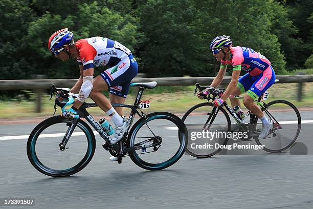 Johnny Hoogerland of Netherlands and Vacansoleil-DCM and Damiano Cunego of Italy and Lampre Merida give chase to the breakaway during stage fourteen...