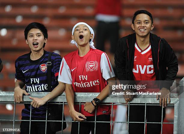 Arsenal fans watch a training session in Indonesia for the club's pre-season Asian tour at the Gelora Bung Karno Stadium on July 13, 2013 in Jakarta,...