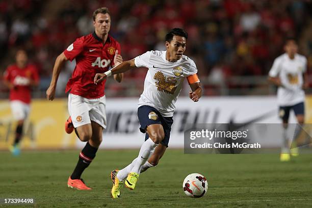 Teeratep Winothai of the Singha All Star XI makes a break against Manchester United during the friendly match between Singha All Star XI and...