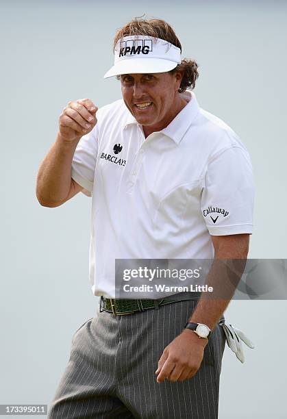 Phil Mickelson of the United States reacts to a birdie putt on the 18th green during the third round of the Aberdeen Asset Management Scottish Open...