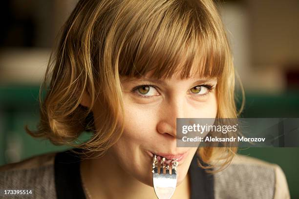 young woman enjoying food - fork stock-fotos und bilder