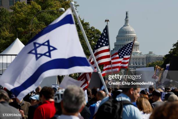People gather for a 'Stand With Israel Rally' in Freedom Plaza on October 13, 2023 in Washington, DC. Organized by the Jewish Community Relations...