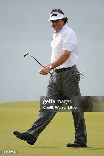 Phil Mickelson of the United States reacts to a birdie putt on the 18th green during the third round of the Aberdeen Asset Management Scottish Open...