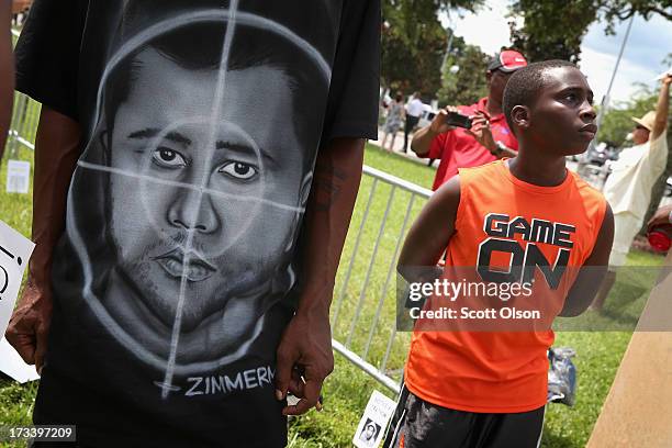 Demonstrator wears a shirt with a picture of George Zimmerman as a target during a protest in front of the Seminole County Criminal Justice Center...