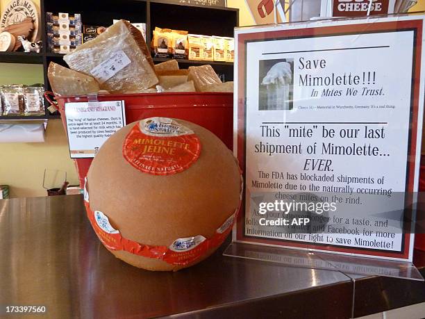 France-cheese-food-health-distribution A sign reads "Save Mimolette!!!" at Cheestique in Arlington, Virginia, on July 11, 2013. Jill Erber, the owner...