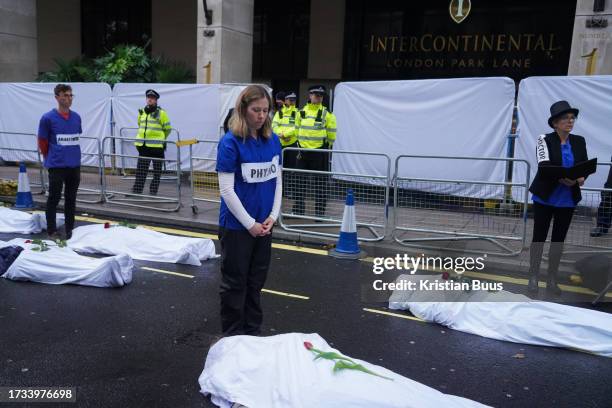 Health professionals from Health for Extinction Rebellion stage a die-in outside the Energy Intelligence forum at the Hotel InterContinental on the...