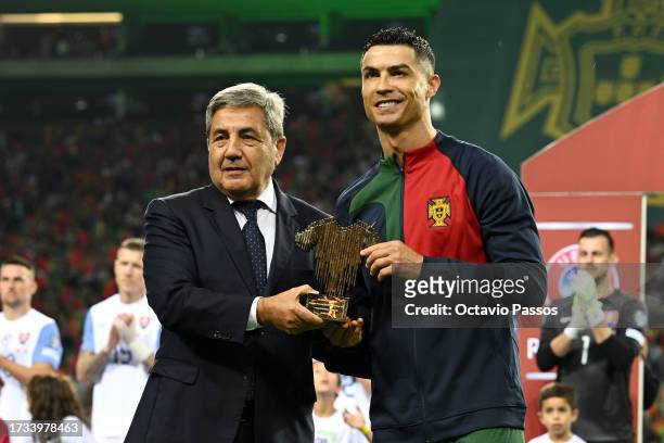 Cristiano Ronaldo of Portugal is presented with an award to mark their 200th appearance for the Portugal men's national team prior to the UEFA EURO...