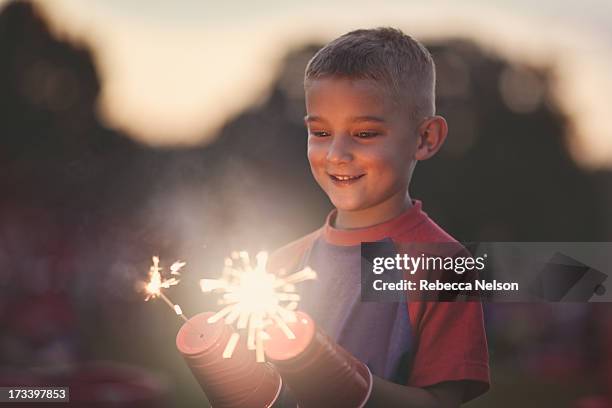 young boy with sparklers - sparkler stock pictures, royalty-free photos & images