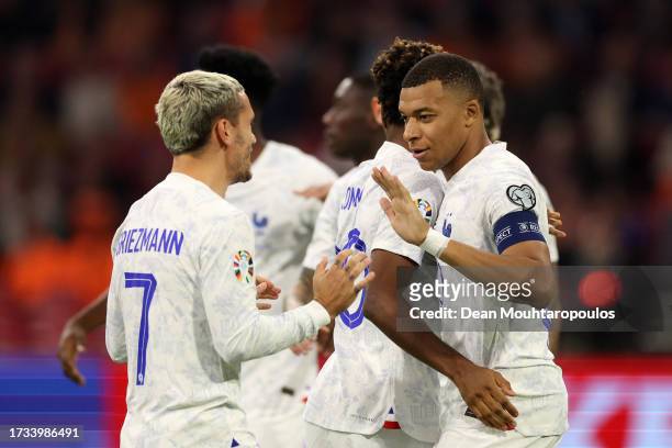 Kylian Mbappe of France celebrates with teammates after scoring the team's first goal during the UEFA EURO 2024 European qualifier match between...