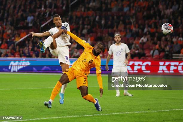 Kylian Mbappe of France scores the team's first goal past Lutsharel Geertruida of Netherlands during the UEFA EURO 2024 European qualifier match...