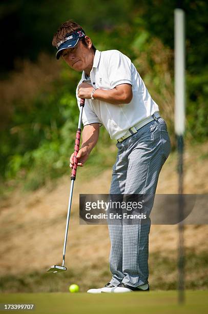 Joe Ozaki hits his first put on the 10th green during the third round of the 2013 U.S. Senior Open Championship at Omaha Country Club on July 13,...