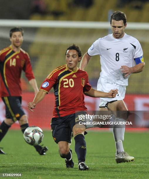 Spanish Santi Cazorla fights for the ball with New Zealand Tim Brown next to Spanish Xabi Alonso during the FIFA Confederations Cup football match...