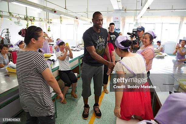 Dwyane Wade shows his appreciation to the factory workers at the Li-Ning shoe manufacturing factory that works on his 'Way of Wade' shoes and thanks...