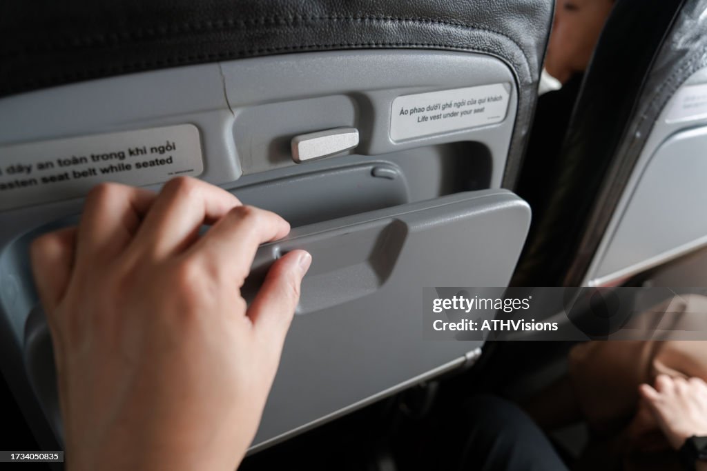 Woman Hand Close Airplane Tray Table