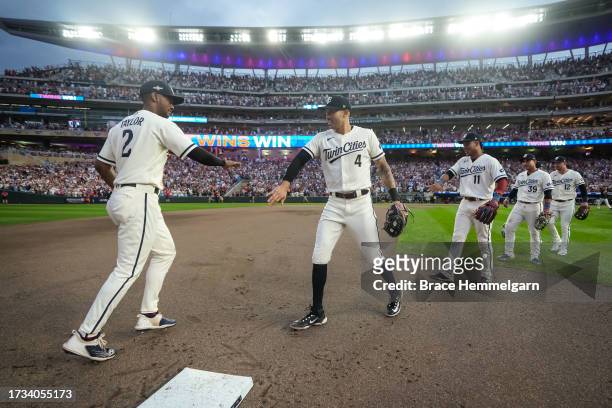Carlos Correa of the Minnesota Twins celebrates with Michael A. Taylor during game one of the Wild Card Series against the Toronto Blue Jays on...