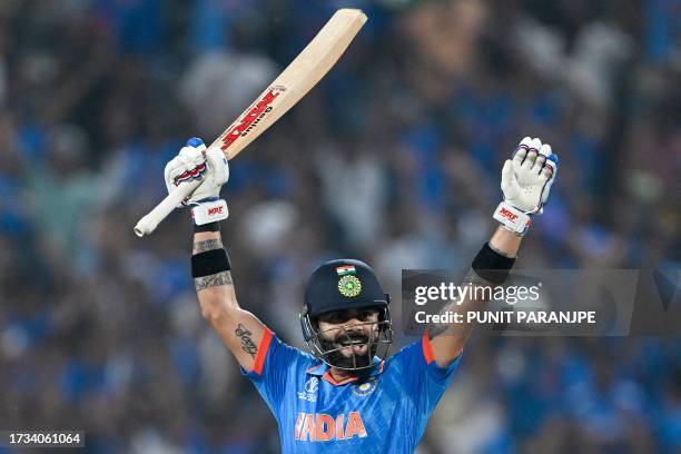 India's Virat Kohli celebrates after scoring a century during the 2023 ICC Men's Cricket World Cup one-day international match between India and...