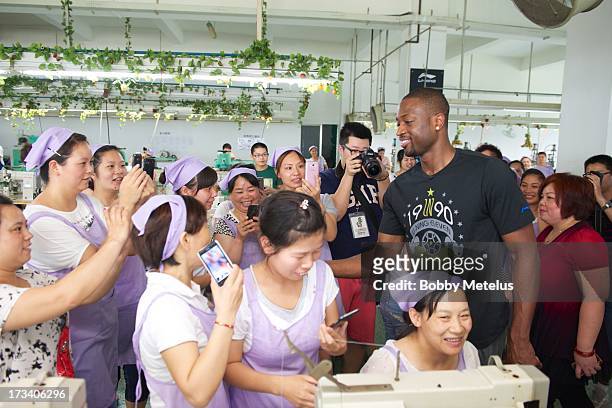 Dwyane Wade shows his appreciation to the factory workers at the Li-Ning shoe manufacturing factory by shaking everyone's hand that works on his 'Way...