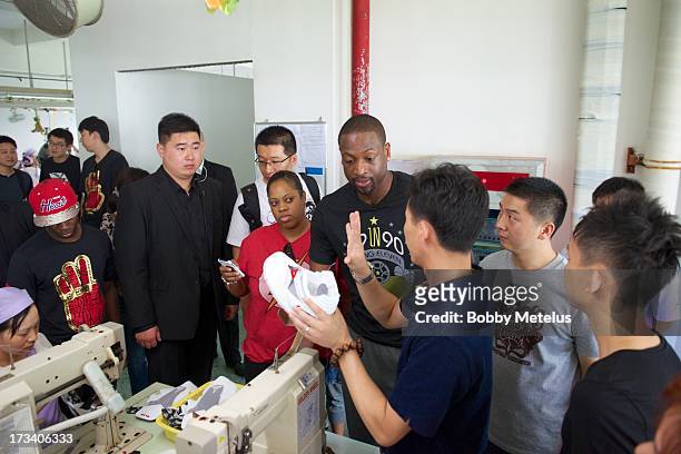 Dwyane Wade takes a tour around the Li-Ning shoe manufacturing factory where his "Way of Wade" brand is produced on July 12, 2013 in Tai Cang, China....