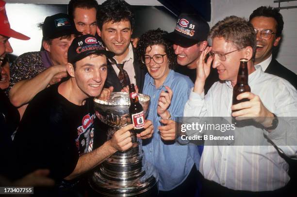 Denis Savard of the Montreal Canadiens celebrates with the Stanley Cup Trophy in the locker room after defeating the Los Angeles Kings in Game 5 of...