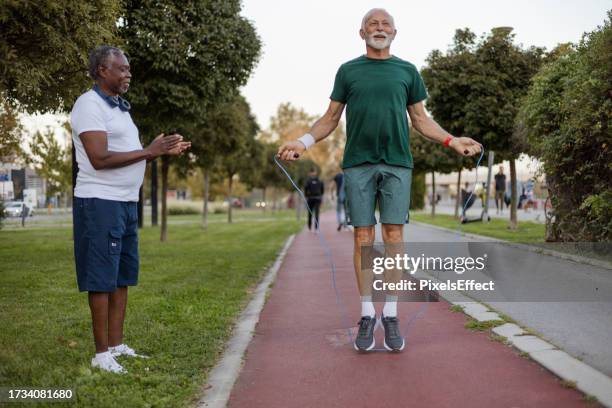 senior man doing exercise with jump rope - only senior men stock pictures, royalty-free photos & images