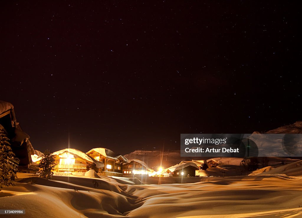 Chalets in snowy landscape in the Alps.