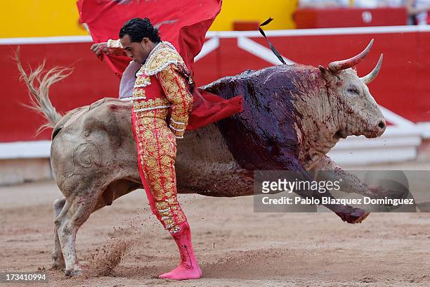 Bullfighter Ivan Fandino performs with a Fuente Ymbro's fighting bull on the eighth day of the San Fermin Running Of The Bulls festival on July 13,...