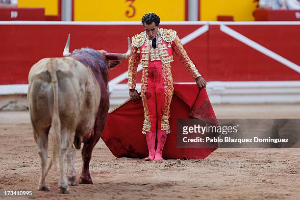 Bullfighter Ivan Fandino performs with a Fuente Ymbro's fighting bull on the eighth day of the San Fermin Running Of The Bulls festival on July 13,...