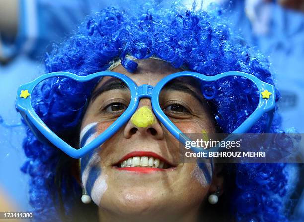 Uruguay's fan with her face painted in colours of her national flag cheers prior to their final football match against France at the FIFA Under 20...