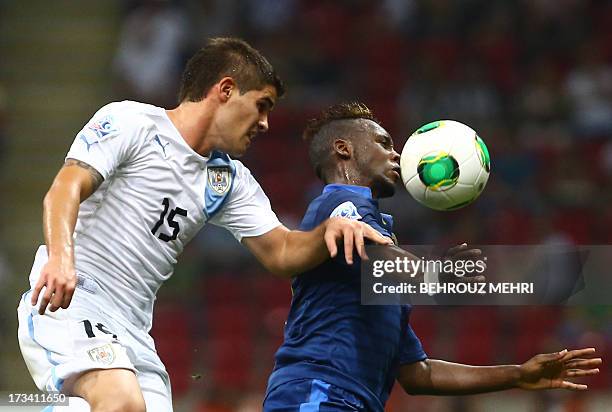 Jean Christophe Bahebeck of France vies with Gino Acevedo of Uruguay during their final football match at the FIFA Under 20 World Cup at Turk Telecom...