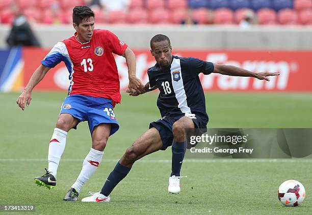 Ariel Rodriguez of Costa Rica and Evral Trapp of Belize battle for the ball during the second half of a CONCACAF Gold Cup match July 13, 2013 at Rio...