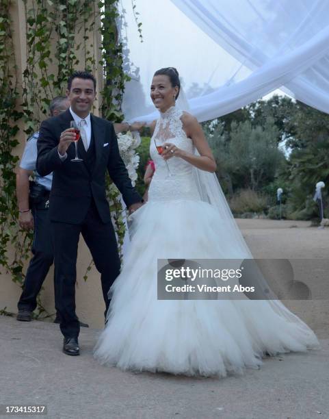 Nuria Canillera and Xavi Hernandez pose for the press after their wedding at the Marimurtra Botanical Gardens on July 13, 2013 in Barcelona, Spain.