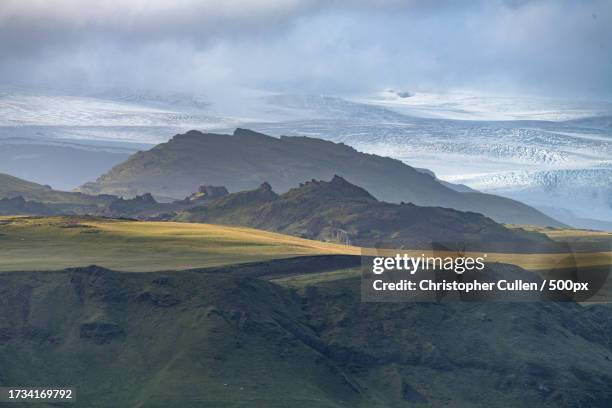 scenic view of snowcapped mountains against sky - katla volcano stockfoto's en -beelden