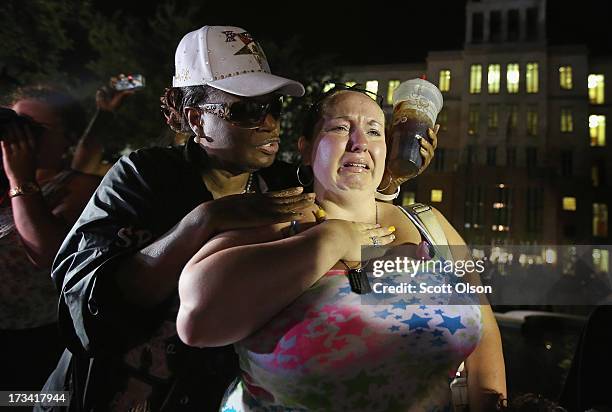 Kat Crowe and Melinda O'Neal comfort each other in front of the Seminole County Criminal Justice Center after learning George Zimmerman had been...