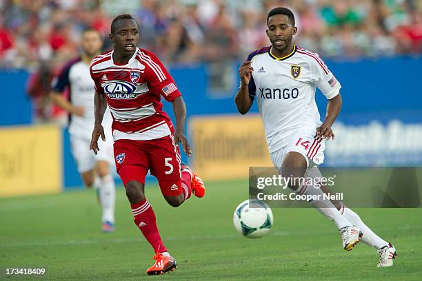 Yordany Alvarez of Real Salt Lake is defended by Jair Benitez of FC Dallas on July 13, 2013 at FC Dallas Stadium in Frisco, Texas.