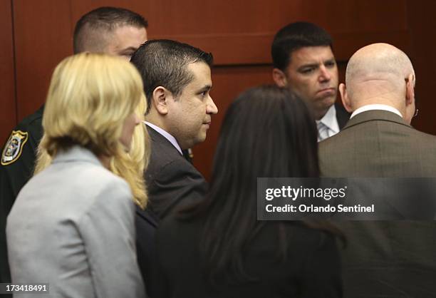 George Zimmerman stands with his defense team after receiving a not guilty verdict in his trial at the Seminole County Criminal Justice Center in...