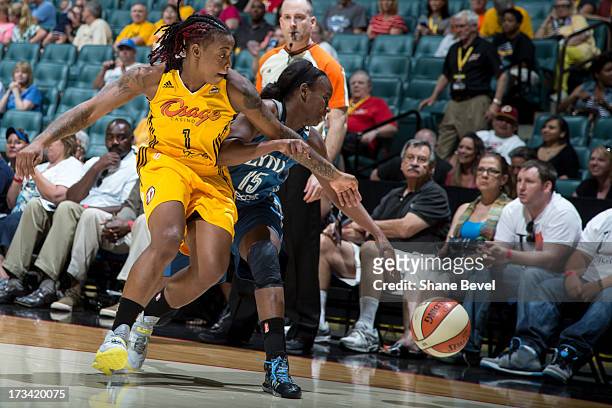 Riquna Williams of the Tulsa Shock bats the ball away from Sugar Rodgers of the Minnesota Lynx during the WNBA game on July 13, 2013 at the BOK...