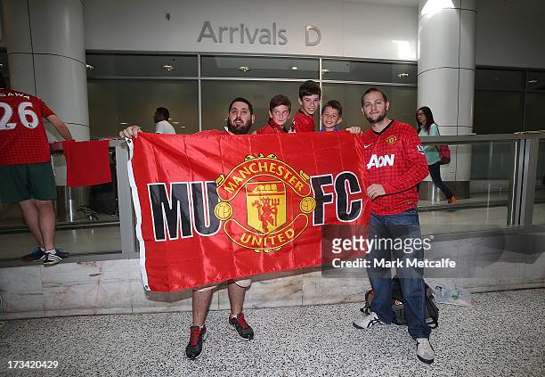 Manchester United fans show their support before the team arrive at Sydney International Airport on July 14, 2013 in Sydney, Australia.