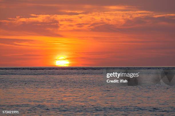 gorgeous sunset near manado, north sulawesi, indonesia - indonesia beach stock pictures, royalty-free photos & images